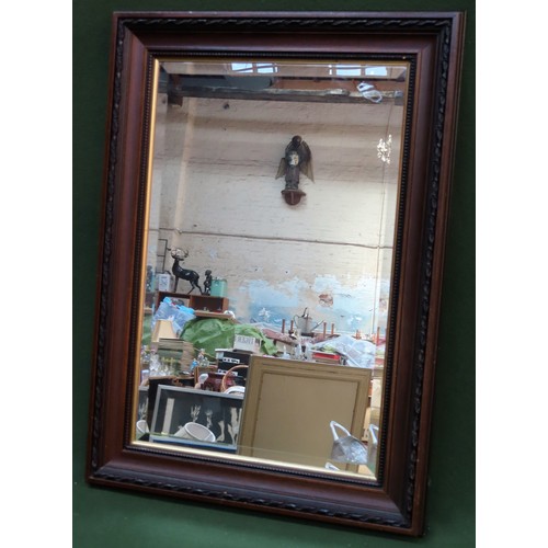 226 - 20th century wooden framed and bevelled wall mirror. Approx. 80 x 57cm