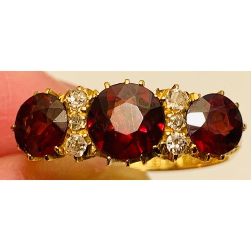 223 - 18ct GOLD RING SET WITH ONE GARNET APPROX 1.75ct, TWO GARNETS APPROX 1ct, FOUR DIAMONDS APPROX 0.04c... 