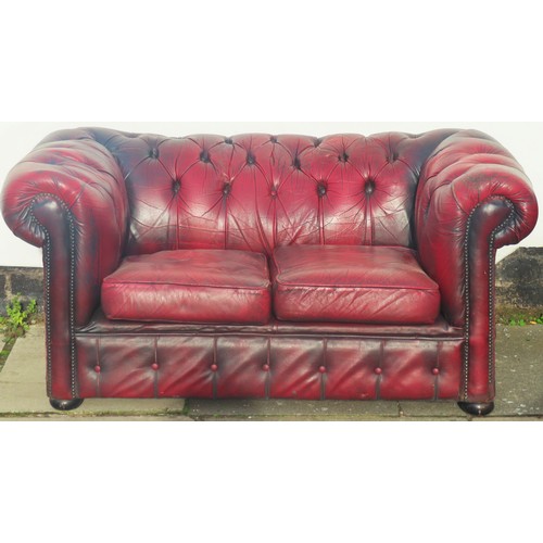 6 - Oxblood red leather upholstered two seater Chesterfield settee. Approx. 70cm H x 152cm W x 88cm D