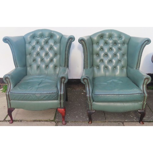 39 - Pair of 20th century green leather upholstered wing armchairs. Approx. 102cm H x 90cm W x 80cm D