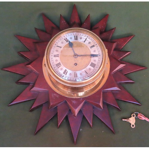 11 - 19th century brass circular ships clock, on mahogany star form wall mount. Mount Approx. 58.5cms Dia... 