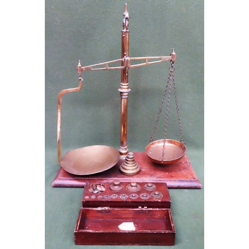 107 - Set of vintage Bartlett & Sons brass weighing scales, mounted on mahogany stand, with various brass ... 