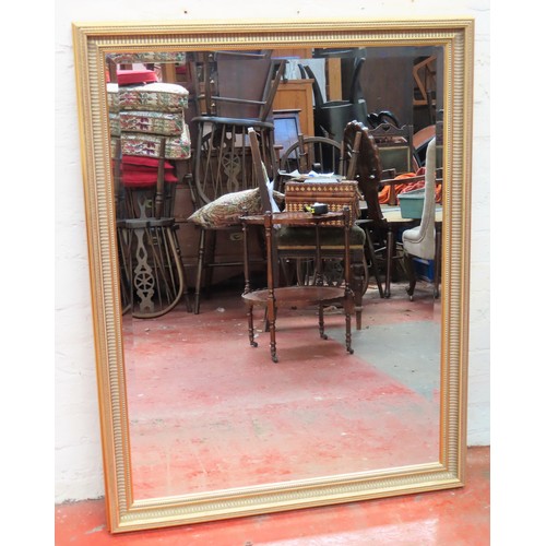 113 - 20th century gild framed and bevelled wall mirror. Approx. 111cms x 88cms