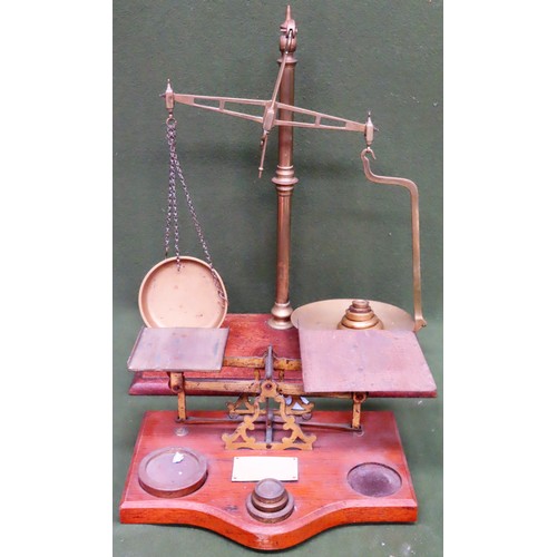 131 - Two part brass weighing scales sets, both mounted on wooden stands