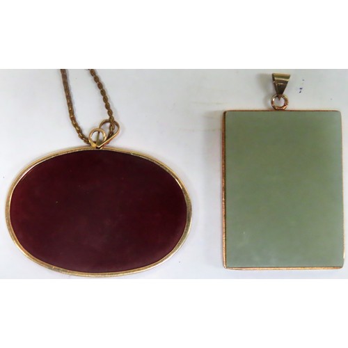 300 - Two semi precious stone mounted gold coloured pendants, one with chain