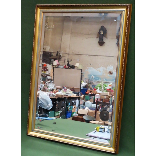 28 - 20th century gilded and bevelled wall mirror. Approx. 75cms x 49cms