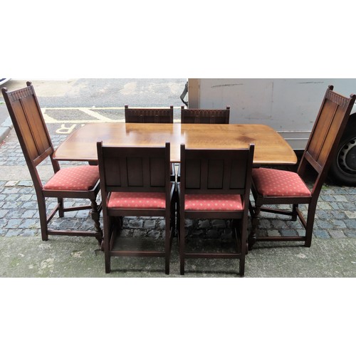 12 - Ercol mid 20th century dark oak refectory type dining table, with six (4+2) Ercol linenfold decorate... 