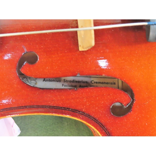 19 - Cased Violin with bow, bearing a label reading 'Antonius Stradivatius'. Approx.. 59cms L