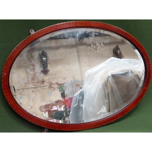 55 - Mahogany bevelled and inlaid oval wall mirror. App. 57 x 82cm