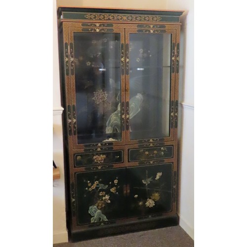 15 - Oriental Mid 20th century lacquered and gilded two door display cabinet, decorated with birds and fo... 