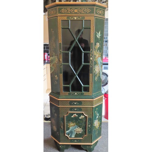 33 - Oriental Mid 20th century two section lacquered and gilded single door display cabinet, decorated wi... 