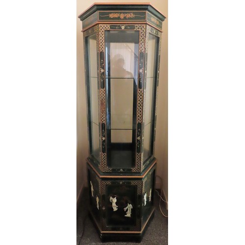 27 - Oriental Mid 20th century two section lacquered and gilded hexagonal single door display cabinet, de... 