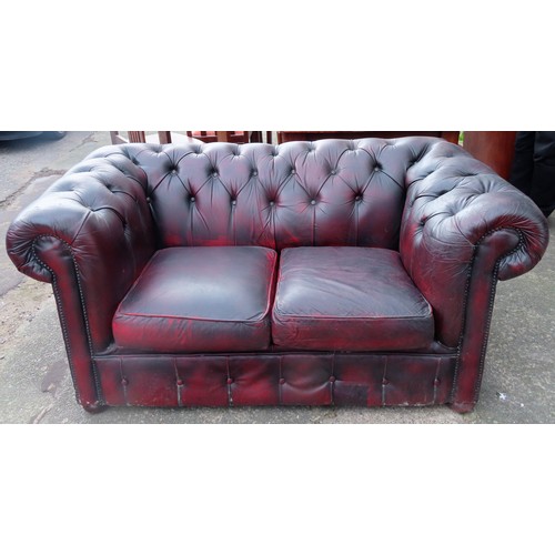 9 - 20th century oxblood red button back Chesterfield two seater settee. App. 72cm H x 152cm W x 85cm D