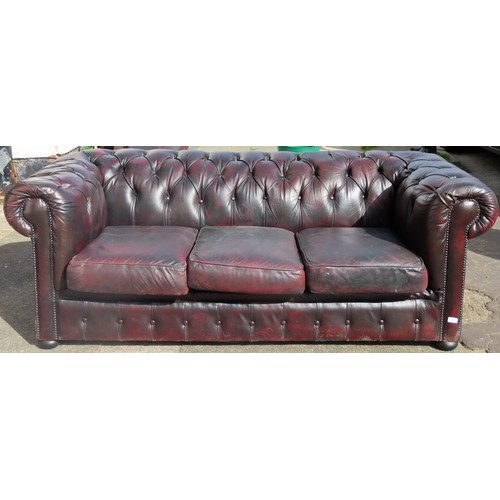 21 - 20th century oxblood red button back Chesterfield three seater settee. App. 70cm H x 175cm W x 76cm ... 