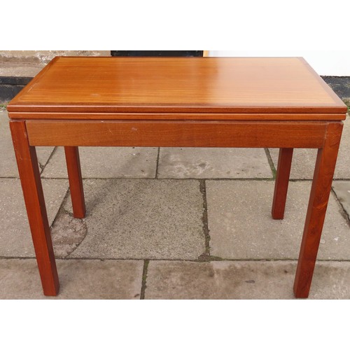 72 - Mid 20th century teak coloured campaign style fold over games table with felt lined interior. App. 7... 