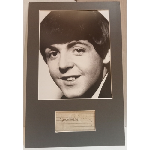 55 - Paul McCartney signature on lined paper mounted with black & white photograph.