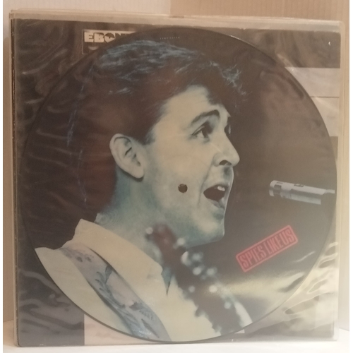 64 - A collection of Paul McCartney records including Spies Like Us 12” Picture Disc, Ebony & Ivory 12”, ... 