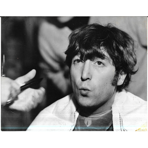 107 - Four original photographs of John Lennon, two feature John getting his haircut prior to filming of H... 