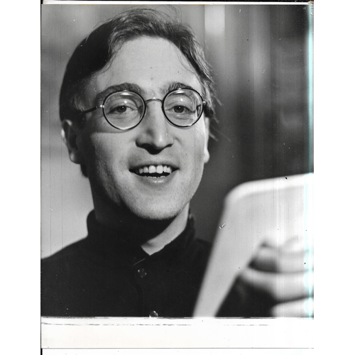 107 - Four original photographs of John Lennon, two feature John getting his haircut prior to filming of H... 