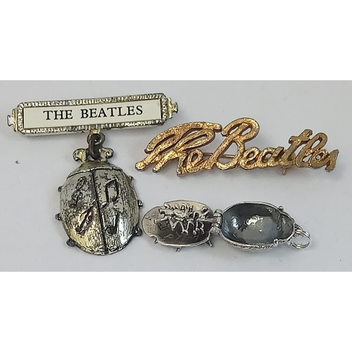 189 - Three pieces of original Beatles jewellery including Beatles Script Brooch, a Silver Beetles Charm w... 