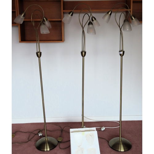 40 - Three 20th century three sconce standard lamps, with glass shades, plus three spare shades. Approx. ... 