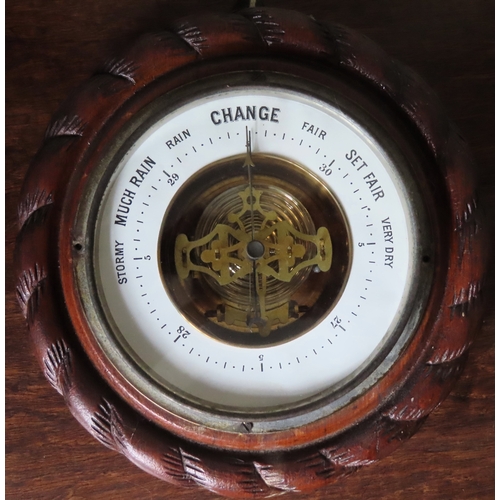 107 - Carved oak framed circular aneroid barometer with enamelled dial