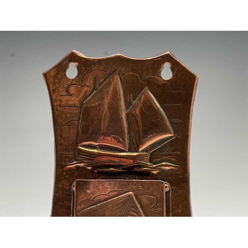 10 - A Herbert Dyer (1898-1974) copper wall mounted matchbox holder, the plaque repousse decorated with a... 