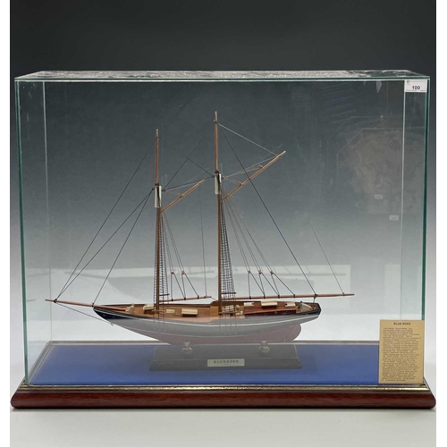 100 - A painted and wood model of the Canadian racing schooner Blue Nose, on a titled stand and contained ... 