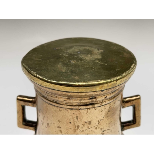 102 - An 18th century bronze pestle and mortar with twin lug handles. Height of the mortar 14cm, diameter ... 