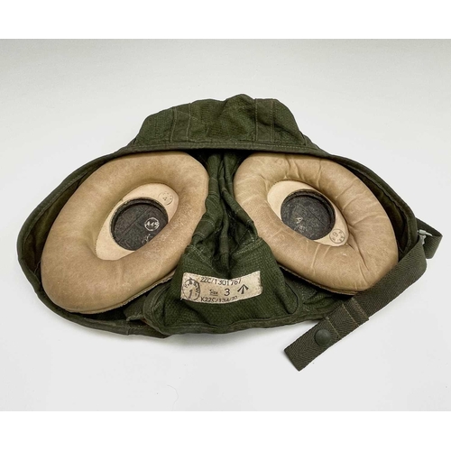 116 - A green canvas and leather pilot's flying helmet, size 3, with stitched in ministry label, stamped P... 