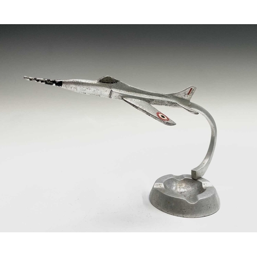 117 - An aluminium ashtray, modelled with a fighter jet, height 15.5cm, together with a cast plaque for Wa... 