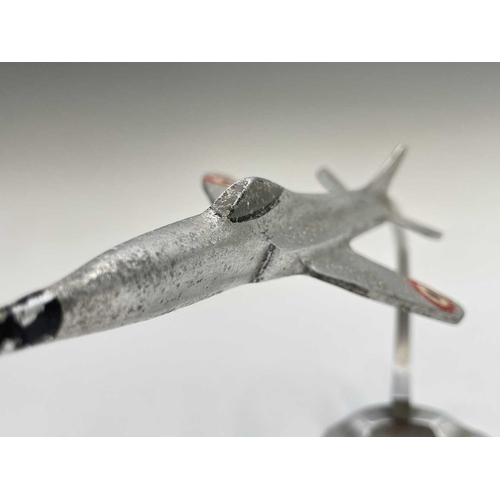 117 - An aluminium ashtray, modelled with a fighter jet, height 15.5cm, together with a cast plaque for Wa... 