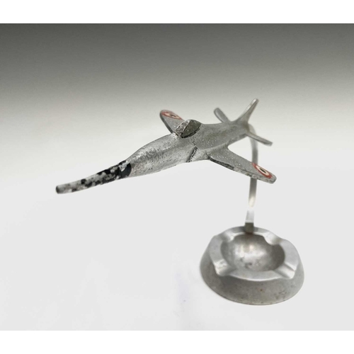 117 - An aluminium ashtray, modelled with a fighter jet, height 15.5cm, together with a cast plaque for Wa... 