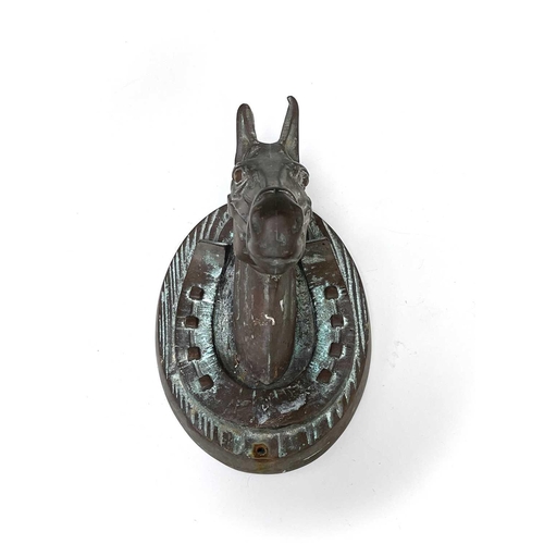 137 - A bronze horse's mask within a horseshoe raised on wood grain effect oval wall mount. Height 21cm, w... 