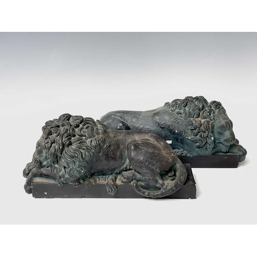 139 - A pair of verdigris bronze effect resin Canova lion ornaments. Height 14cm, width 32cm, depth 12cm.