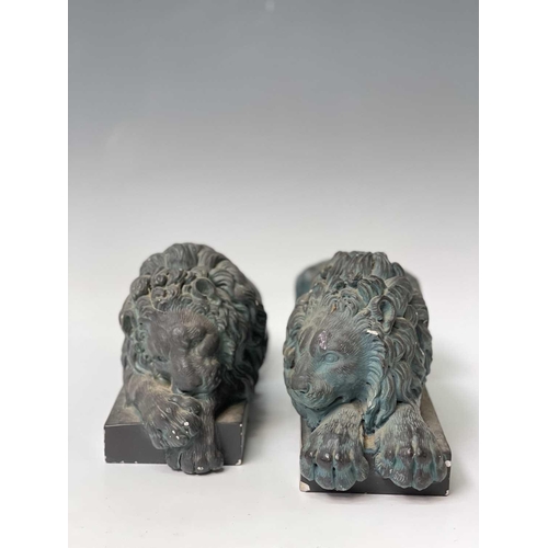 139 - A pair of verdigris bronze effect resin Canova lion ornaments. Height 14cm, width 32cm, depth 12cm.