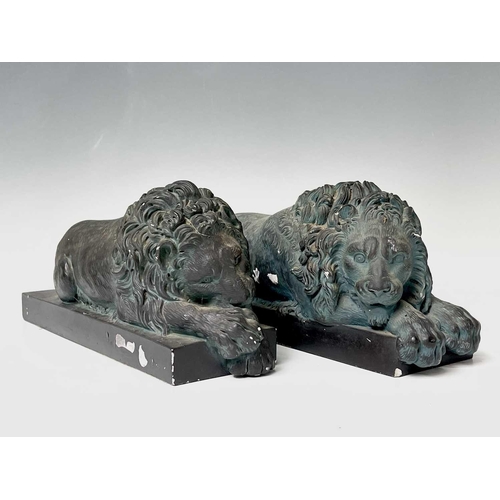 139 - A pair of verdigris bronze effect resin Canova lion ornaments. Height 14cm, width 32cm, depth 12cm.