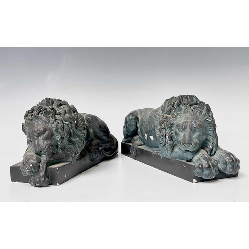 139 - A pair of verdigris bronze effect resin Canova lion ornaments. Height 14cm, width 32cm, depth 12cm.