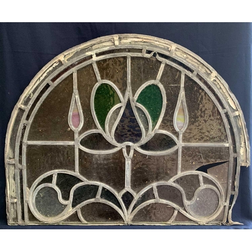 141 - An early 20th century leaded and stained glass panel of arched form. Height 45cm, width 59cm.