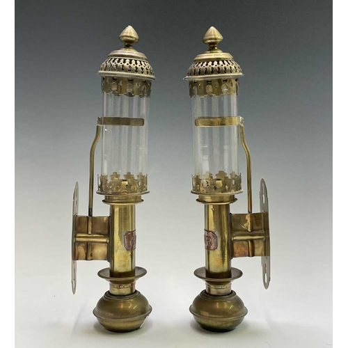 142 - A pair of brass candleholders, with applied GWR labels and glass shades, height 35cm, together with ... 