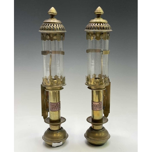 142 - A pair of brass candleholders, with applied GWR labels and glass shades, height 35cm, together with ... 