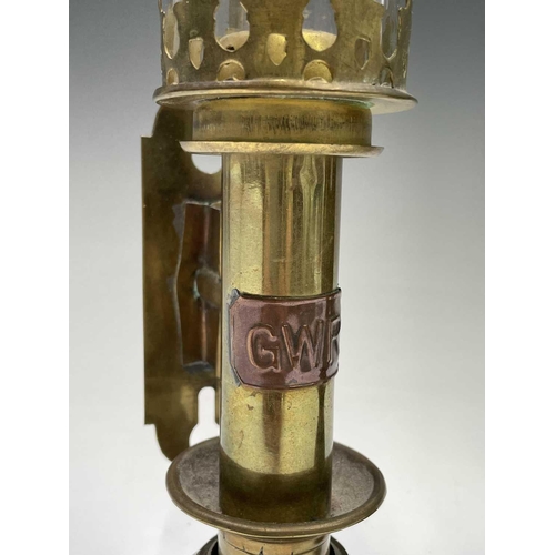 142 - A pair of brass candleholders, with applied GWR labels and glass shades, height 35cm, together with ... 