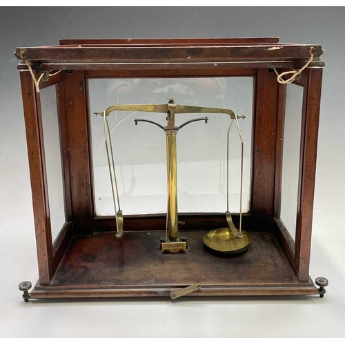 143 - A brass precision laboratory balance, by W & T Avery Ltd, circa 1900, contained in a glazed mahogany... 