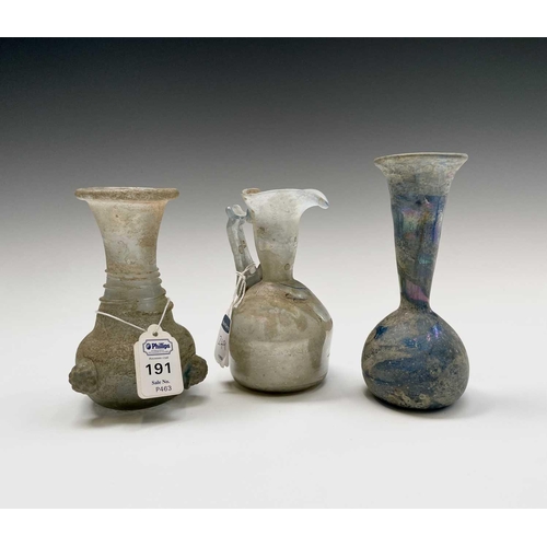 15 - Three iridescent glass vessels, possibly Roman, comprising a ewer, height 13cm, and two vases. Prove... 