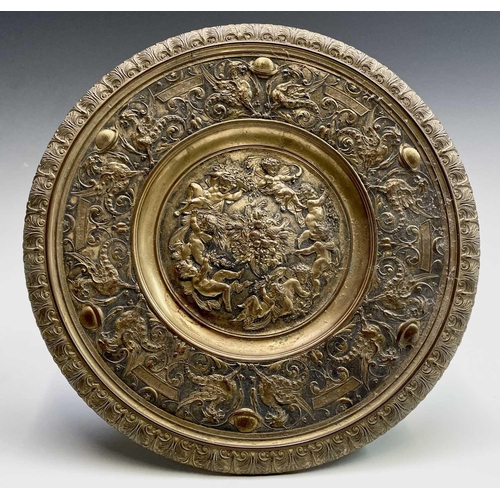 16 - A gilt metal comport, Continental, 19th century, embossed in high relief with cherubs to the centre,... 