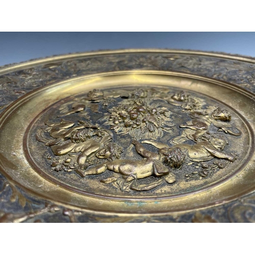 16 - A gilt metal comport, Continental, 19th century, embossed in high relief with cherubs to the centre,... 