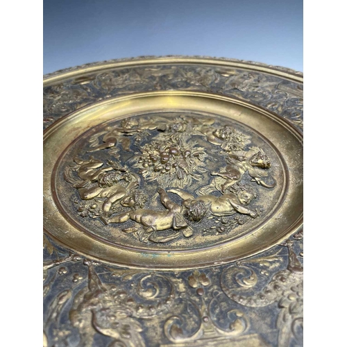 16 - A gilt metal comport, Continental, 19th century, embossed in high relief with cherubs to the centre,... 