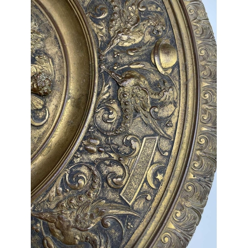 16 - A gilt metal comport, Continental, 19th century, embossed in high relief with cherubs to the centre,... 