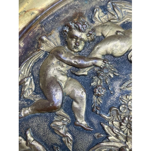 16 - A gilt metal comport, Continental, 19th century, embossed in high relief with cherubs to the centre,... 