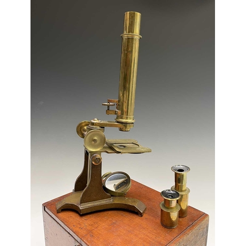 164 - A late Victorian brass microscope, with lenses, contained in a mahogany case with fitted drawer, ove... 